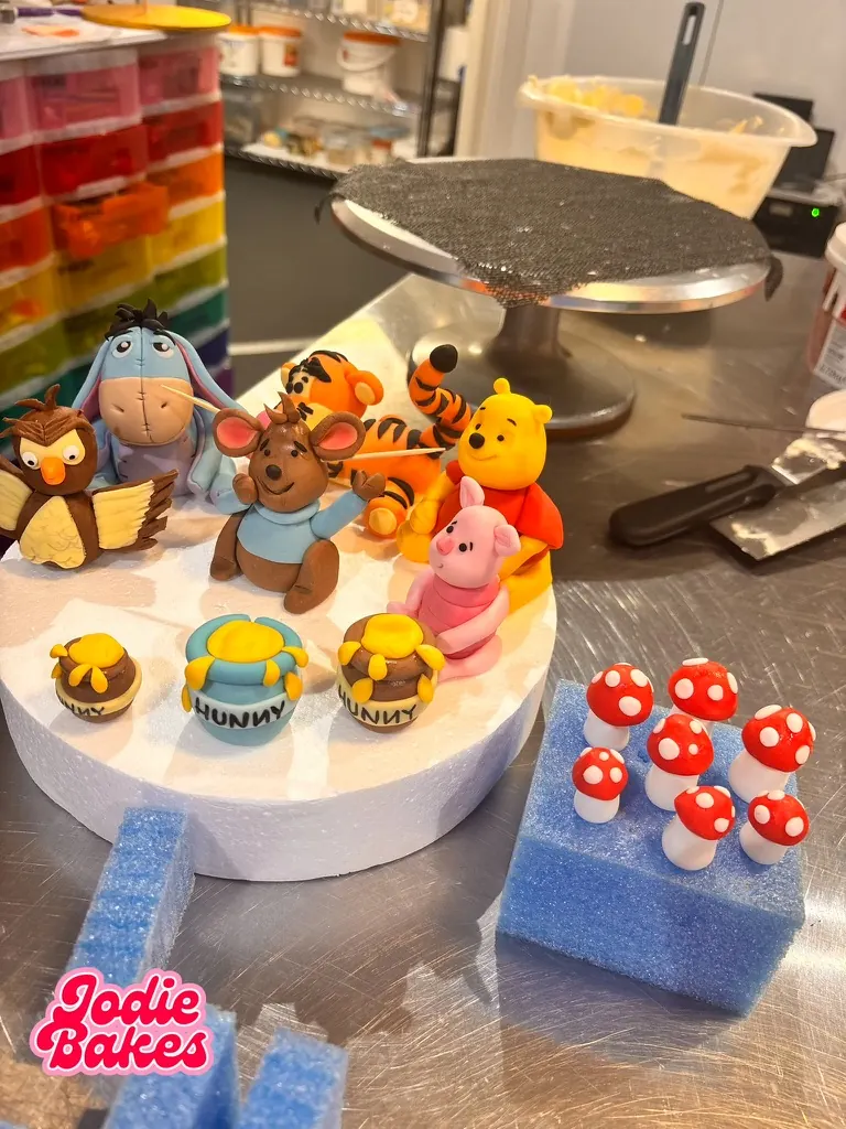 Winnie the Pooh and friends sugar cake toppers with honey pots and toadstools, by Jodie Bakes, Leeds